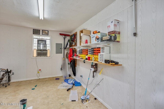 interior space with cooling unit, electric panel, and a textured ceiling