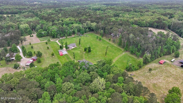 birds eye view of property featuring a view of trees and a rural view