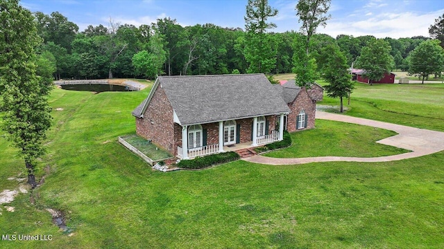 view of front of home featuring a front lawn, a shingled roof, french doors, a porch, and brick siding