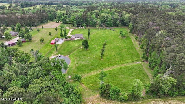 bird's eye view featuring a wooded view and a rural view