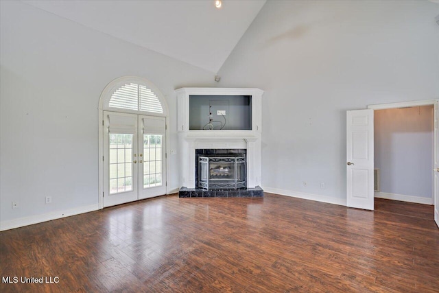unfurnished living room featuring high vaulted ceiling, wood finished floors, french doors, a tile fireplace, and visible vents