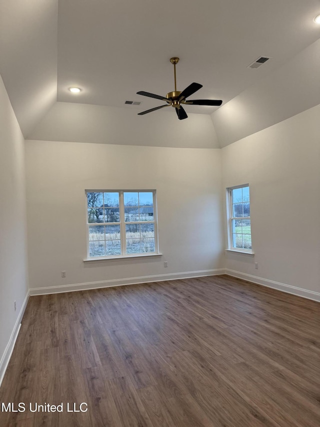 unfurnished room with dark hardwood / wood-style flooring, vaulted ceiling, and ceiling fan