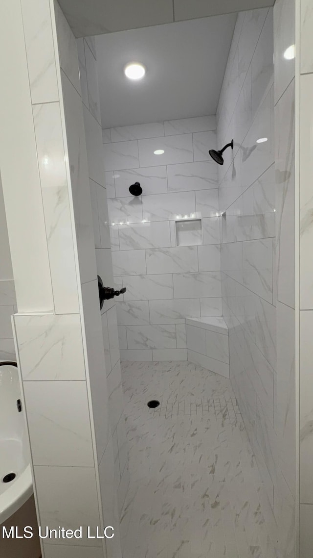 bathroom with tiled shower