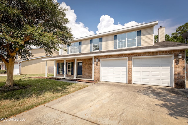 view of front of home with a front yard and a garage