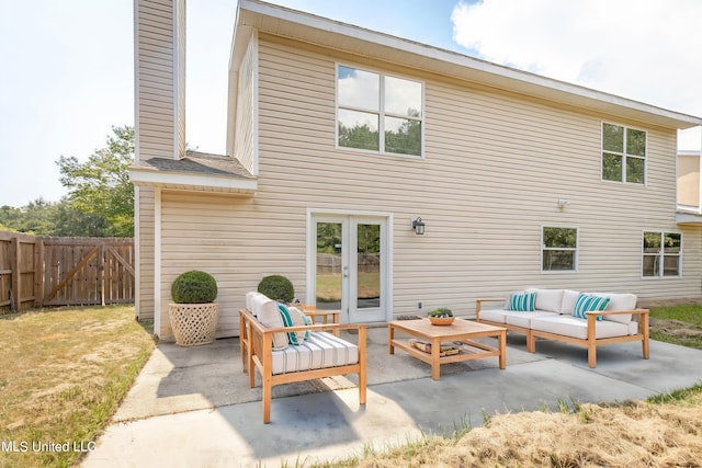 rear view of property with a patio area and an outdoor living space