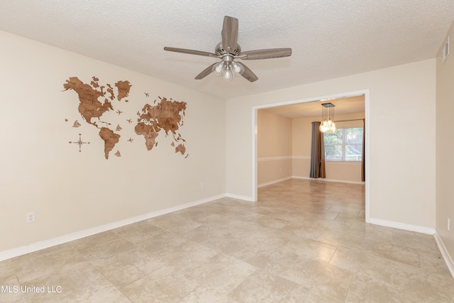 unfurnished room featuring ceiling fan and a textured ceiling