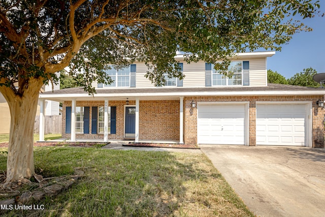 view of front facade featuring a front lawn, covered porch, and a garage