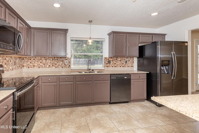 kitchen with tasteful backsplash, sink, hanging light fixtures, stainless steel appliances, and light tile patterned floors