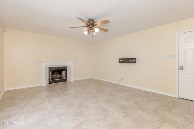 unfurnished living room featuring a textured ceiling, a tiled fireplace, light tile patterned floors, and ceiling fan