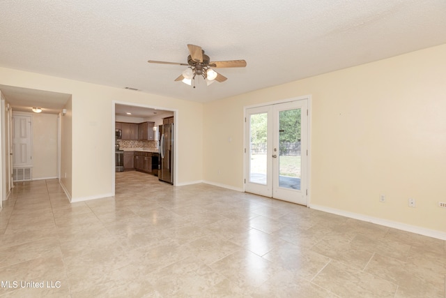 unfurnished living room featuring ceiling fan, a textured ceiling, and light tile patterned floors