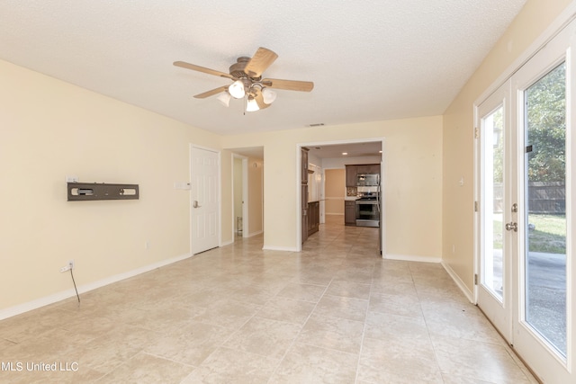 unfurnished room featuring light tile patterned flooring, a textured ceiling, and ceiling fan