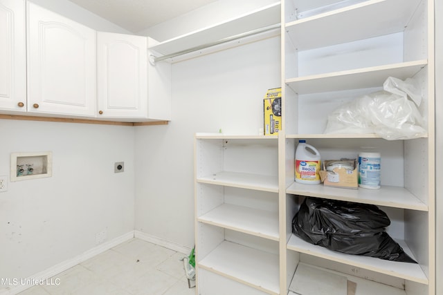 washroom featuring electric dryer hookup, washer hookup, and cabinets