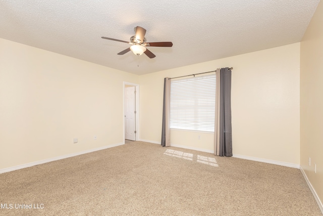 carpeted spare room featuring a textured ceiling and ceiling fan