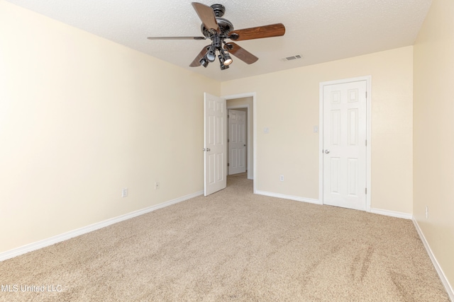 unfurnished bedroom featuring carpet floors, a textured ceiling, and ceiling fan