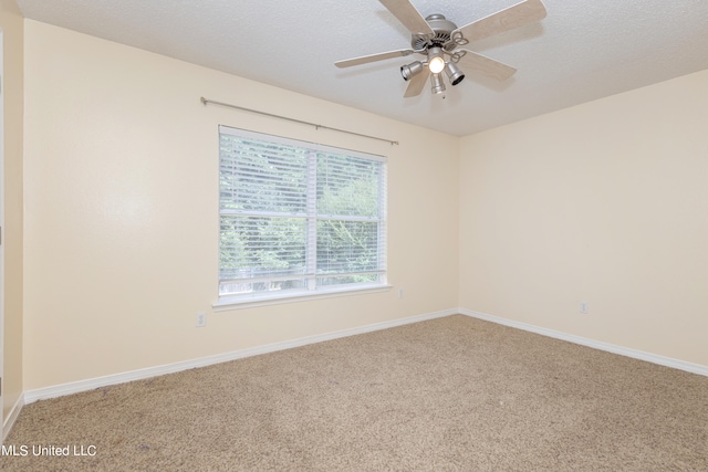 carpeted spare room featuring ceiling fan and a textured ceiling