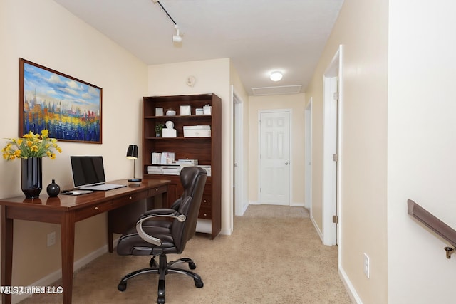 carpeted office featuring rail lighting