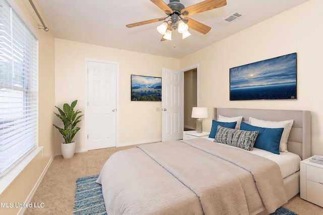 bedroom featuring ceiling fan and light colored carpet