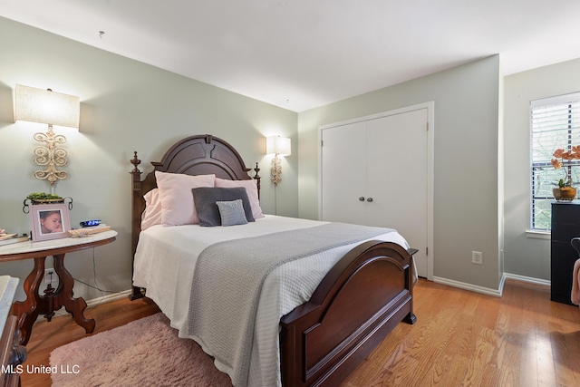 527 Front Beach Dr Unit 17, Ocean Springs, MS 39564 - bedroom featuring light wood-type flooring, baseboards, and a closet