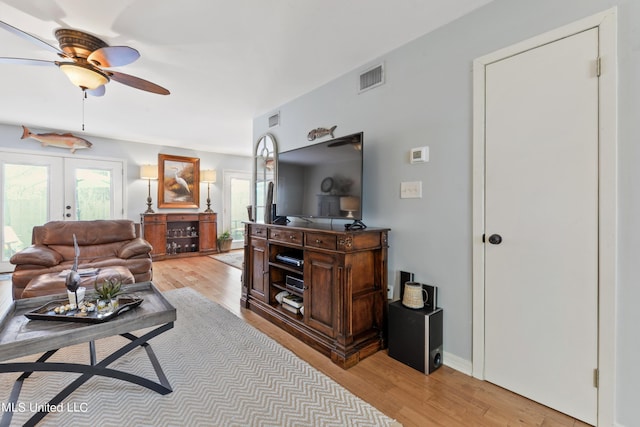 527 Front Beach Dr Unit 17, Ocean Springs, MS 39564 - living room featuring a ceiling fan, light wood finished floors, and french doors