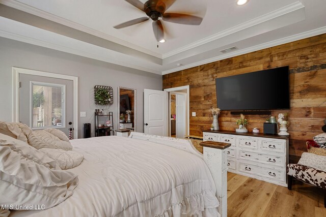 446 Newman Camp Rd, Sumrall, MS 39482 - bedroom with wood walls, recessed lighting, light wood-style flooring, ornamental molding, and a raised ceiling