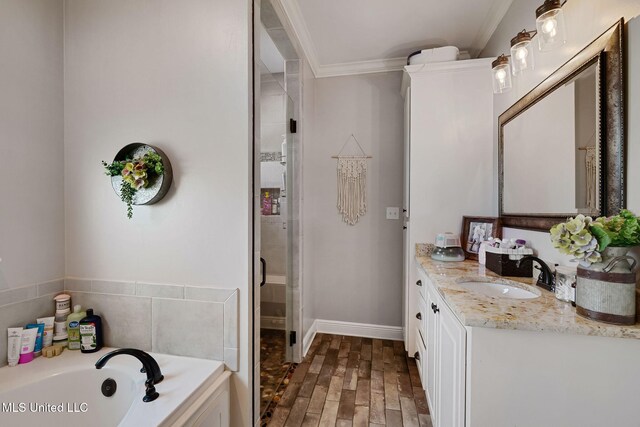 446 Newman Camp Rd, Sumrall, MS 39482 - full bathroom featuring ornamental molding, vanity, a bath, wood finished floors, and a stall shower