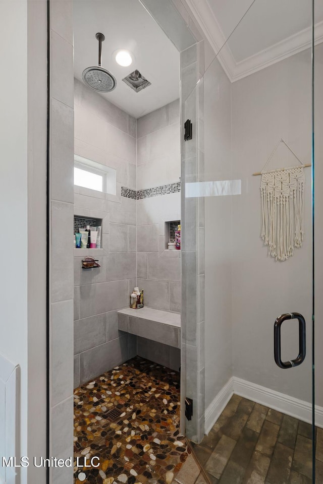 446 Newman Camp Rd, Sumrall, MS 39482 - full bathroom featuring a shower stall, crown molding, and baseboards