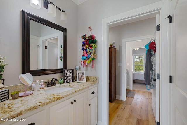 446 Newman Camp Rd, Sumrall, MS 39482 - bathroom featuring vanity, hardwood / wood-style flooring, and baseboards
