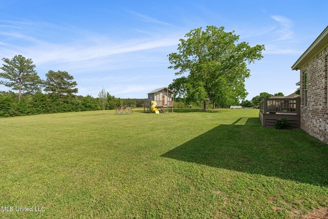 446 Newman Camp Rd, Sumrall, MS 39482 - view of grassy yard with a playground and a deck