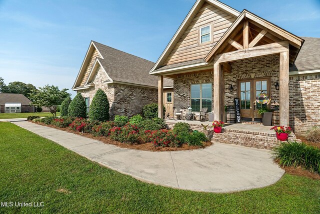 446 Newman Camp Rd, Sumrall, MS 39482 - view of front of house with brick siding, a front yard, and french doors