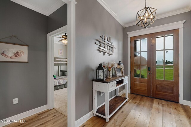 446 Newman Camp Rd, Sumrall, MS 39482 - foyer entrance with french doors, wood finished floors, ornamental molding, baseboards, and a chandelier