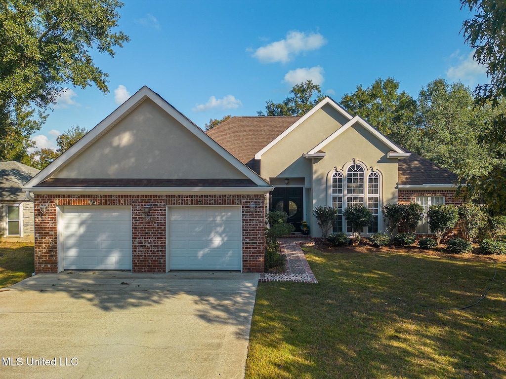 view of front of house with a front yard and a garage