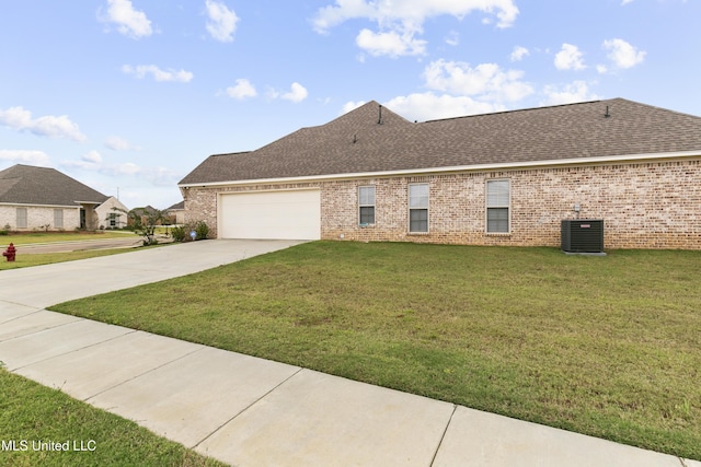 962 Glenwild Cir, Canton, MS 39046 - view of front of home featuring a garage, brick siding, driveway, a front lawn, and a shingled roof