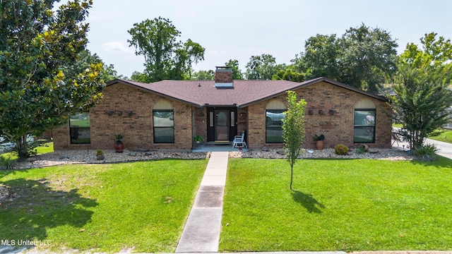 109 Boggs Cir, Long Beach, MS 39560 - view of front of property featuring brick siding, a front lawn, and a chimney