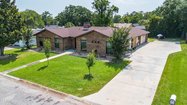 109 Boggs Cir, Long Beach, MS 39560 - ranch-style house featuring brick siding, a garage, concrete driveway, a front lawn, and a chimney