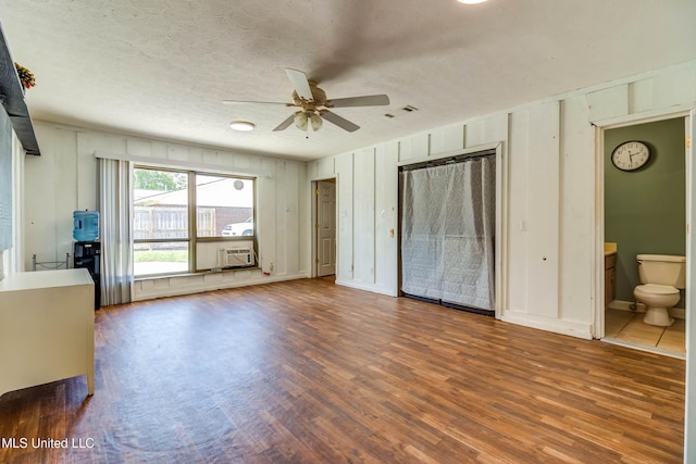 109 Boggs Cir, Long Beach, MS 39560 - unfurnished living room featuring wood finished floors, a ceiling fan, and a textured ceiling