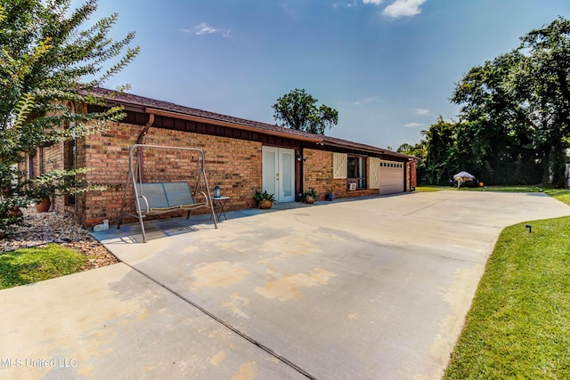 109 Boggs Cir, Long Beach, MS 39560 - ranch-style home featuring a garage, brick siding, and concrete driveway