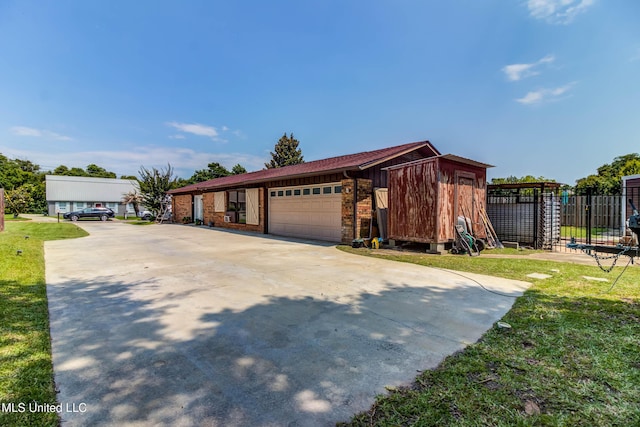 109 Boggs Cir, Long Beach, MS 39560 - view of front of property with an outdoor structure, driveway, and a garage