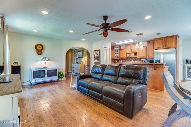 109 Boggs Cir, Long Beach, MS 39560 - living room featuring arched walkways, a ceiling fan, recessed lighting, and light wood-style floors