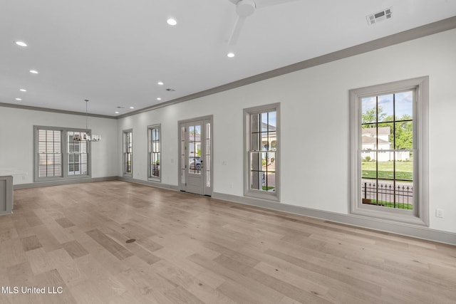 unfurnished living room with a chandelier, light wood-type flooring, recessed lighting, baseboards, and crown molding