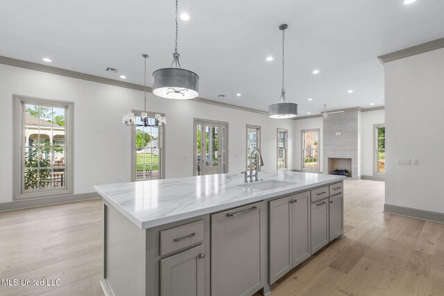 kitchen with a sink, gray cabinets, healthy amount of natural light, recessed lighting, and open floor plan
