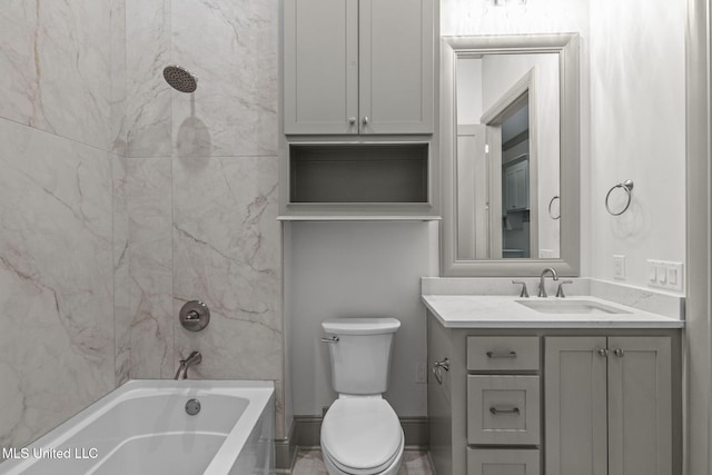 bathroom featuring vanity, toilet, and washtub / shower combination