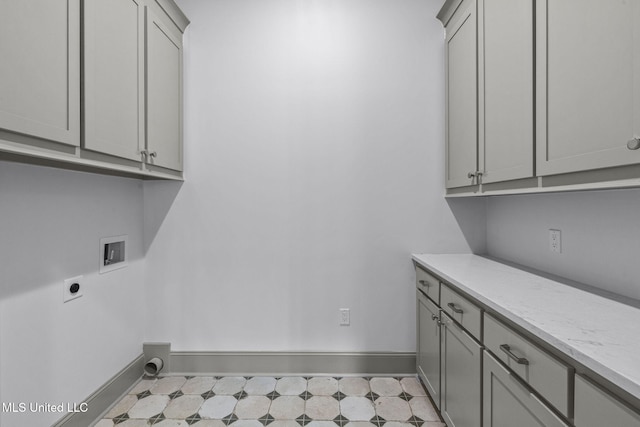 washroom with washer hookup, cabinet space, baseboards, and electric dryer hookup