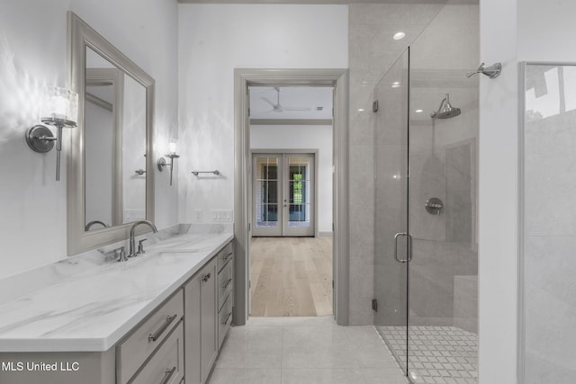 bathroom featuring a stall shower, french doors, vanity, and tile patterned flooring
