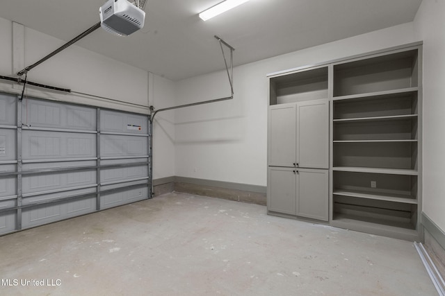 garage with a garage door opener and baseboards