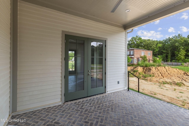 view of exterior entry with french doors and a patio