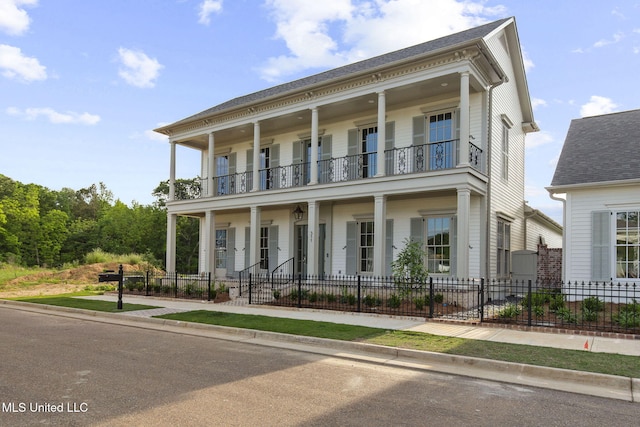 view of front facade with a balcony, a fenced front yard, and a porch