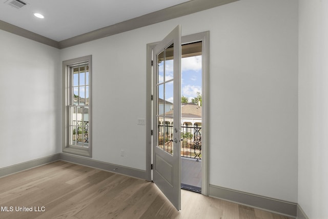 doorway featuring plenty of natural light, light wood-type flooring, baseboards, french doors, and recessed lighting