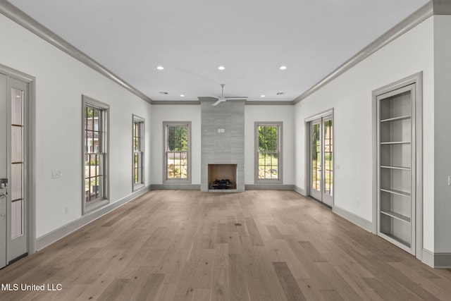 unfurnished living room featuring ornamental molding, ceiling fan, light wood finished floors, a fireplace, and recessed lighting