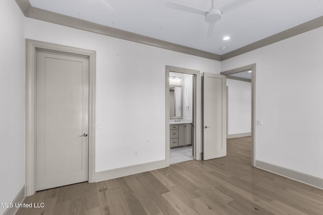 unfurnished bedroom with wood finished floors, baseboards, recessed lighting, and ensuite bath