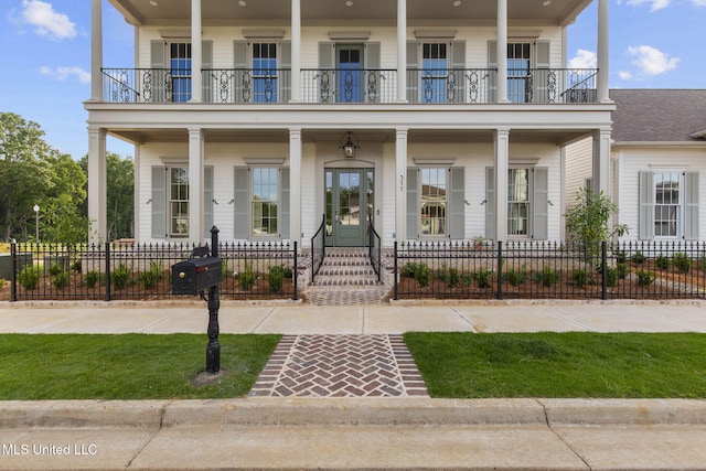 view of front of home featuring a balcony, a porch, and fence